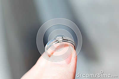 Ring with brilliant in fingers Stock Photo