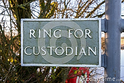 Ring for the custodian sign at Threave Castle ferry crossing on the River Dee Stock Photo