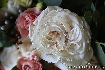 ring diamonds petals fresh rose bud wedding bouquet Stock Photo