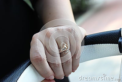 Ring on the hand of the woman he loved, given in honor of the birth of a child Stock Photo