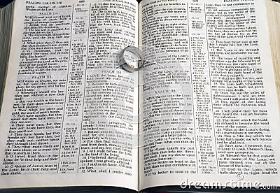 Ring on pages of open bible Stock Photo