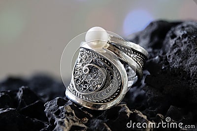 Ring silver jewelry necklace with one pearl on stone background Stock Photo