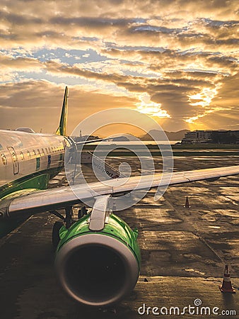 Passenger airplane at sunset waiting for passengers Editorial Stock Photo