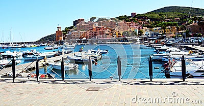 Rio Marina port town, bridge, rock, waves and boats in Tuscany, in Elba island, Italy Editorial Stock Photo