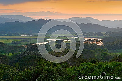 Rio Tarcoles, Carara National Park, Costa Rica. Sunset in beautiful tropic forest landscape. Meander of river Tarcoles. Hills with Stock Photo