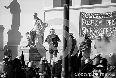 Riot police and protesters during a protest in front of Athens University Editorial Stock Photo