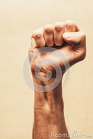 Riot protest fist raised in the air. Male clenched fist Stock Photo