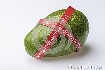 Ripe avocado entwined with ribbon with text Listeria monocytogenes . Stock Photo