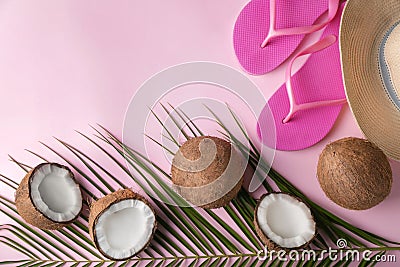 Ripe coconuts, beach hat and flip-flops on color background Stock Photo