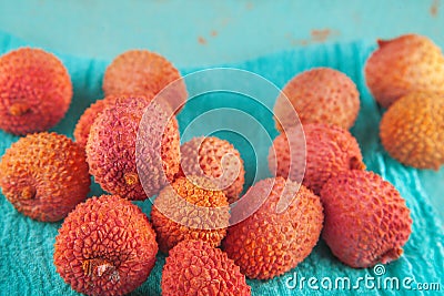 Ripe, colorful lichees decorated on turquoise background with napkin Stock Photo