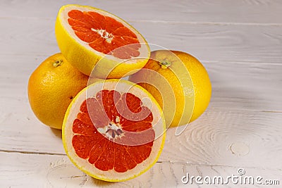 Ripe fresh grapefruits on white wooden table Stock Photo