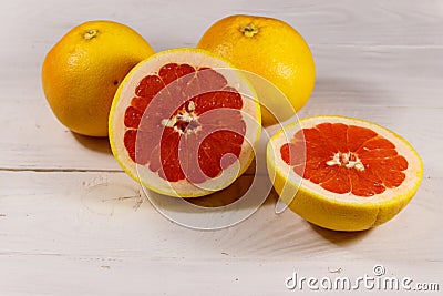 Ripe fresh grapefruits on white wooden table Stock Photo