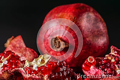 Ripe; fresh pomegranate fruit; on black background. Stock Photo