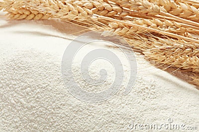 Ears of wheat on heap of flour Stock Photo