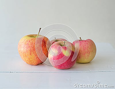 Ripe homemade seasonal apples on white wooden background Stock Photo