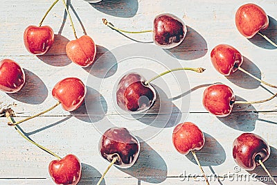 Ripe juicy cherries on azure blue wooden background. Summer berries, top view, flat lay Stock Photo