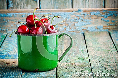 Ripe juicy cherries in the old mug Stock Photo