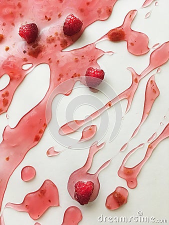 Ripe juicy raspberries of deep saturated raspberry color floating in raspberry jelly on a white background Stock Photo