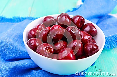 Ripe juicy red cherries in a ceramic bowl Stock Photo