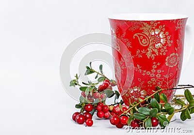 Ripe lingonberries and red cup with ornament Stock Photo