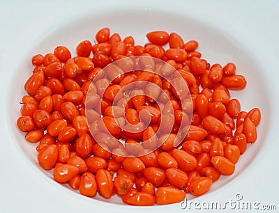 Ripe orange goji berries on the plate. Goji, goji berry, or wolfberrys is the fruit of either Lycium barbarum and an ingredient in Stock Photo