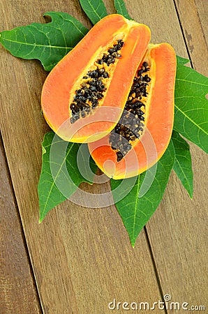 Ripe papaya on wood background. Stock Photo