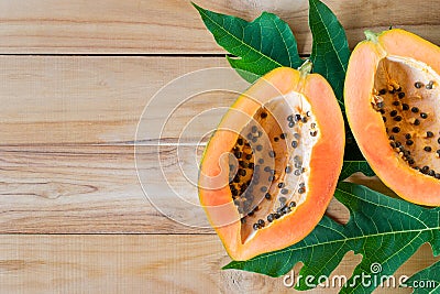 ripe papaya on wood table from above , ripe papaya health benefits. Stock Photo