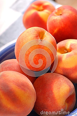 Ripe peaches in a blue bowl Stock Photo