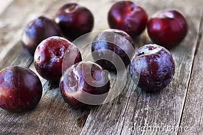 Ripe Plums on the wood backgraund. Stock Photo