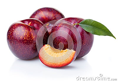 Ripe purple plum fruits with green leaves isolated on white Stock Photo