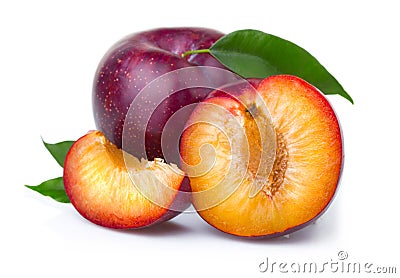 Ripe purple plum fruits with green leaves Stock Photo