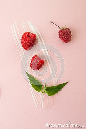 Ripe raspberries, green mint leaves and a smear of sour cream on Stock Photo