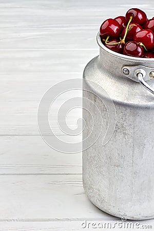 Ripe red cherries in vintage bucket, cropped image. Stock Photo