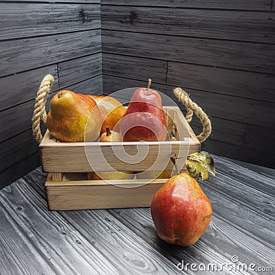 Ripe red pears are packed in a wooden box Stock Photo