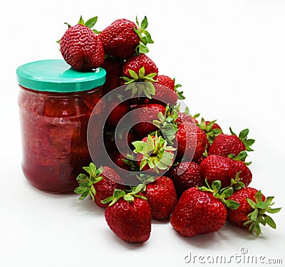 Ripe red strawberries and a jar of strawberry jam on a white Stock Photo