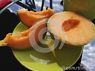 Ripe sliced cantaloupe with bright orange flesh. Stock Photo