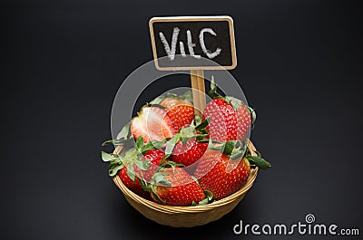 Strawberry in the basket and inscription vitamin c Stock Photo