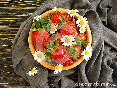 Ripe strawberry, chamomile flower on wooden backgrou Stock Photo