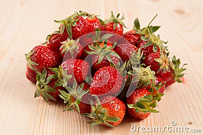 Ripe strawberry fruits, flowers, leaves on white wood table background Stock Photo