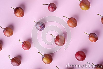 Ripe sweet plum fruits pattern texture, top view, flat lay, pink background Stock Photo