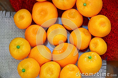 Ripe tangerines lie on the table on a red wool background. The ripening seasund and on a pink napkin. The ripening season of tropi Stock Photo