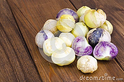 Ripe tomatillo Physalis, Mexican husk tomato on wooden table Stock Photo