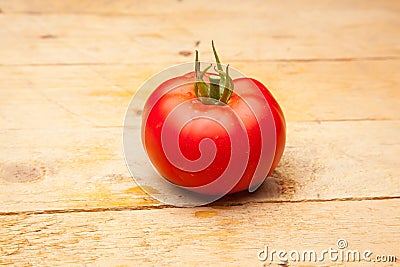 Ripe tomato on wooden background Stock Photo