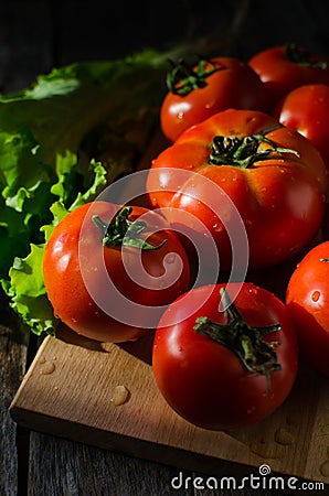 Ripe tomatoes on a cutting Board Stock Photo