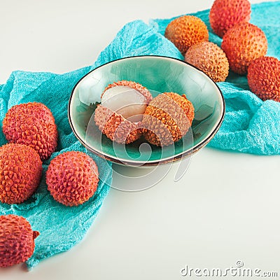 Ripe, vermilion exotic lichees decorated on a white plate kitchen table Stock Photo