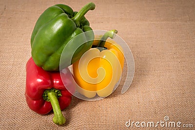 Ripe vibrant colorful peppers on sackcloth Stock Photo