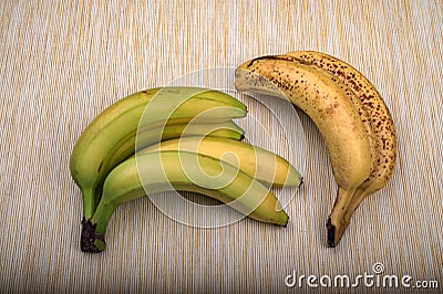 ripe yellow banana on table, dirty spots stuck to it Stock Photo