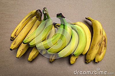 ripe yellow banana on table, dirty spots stuck to it Stock Photo