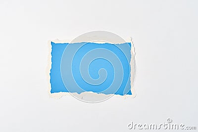Ripped blue paper torn edge sheet on a white background. Template with piece of color paper Stock Photo