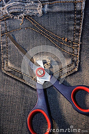 Ripped denim pocket with scissors Stock Photo
